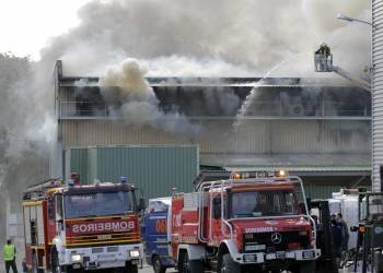 Los bomberos trabajan en el incendio que ha destruido la nave de Frigoríficos Devesa, en la localidad pontevedresa de Caldas de Reis (Foto: EFE)