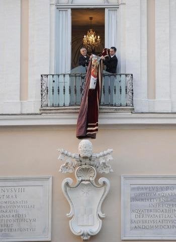 Unos trabajadores del Vaticano retiran el tapiz con el escudo de armas del papa Benedicto XVI del balcón de la residencia estival papal de Castel Gandolfo (Foto: EFE)