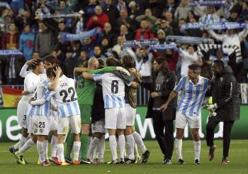 Los jugadores del Málaga celebran la clasificación para los cuartos de final de la Champions. (Foto: DANIEL PÉREZ)