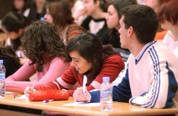 Un grupo de estudiantes españoles asisten a una clase en un aula universitaria.