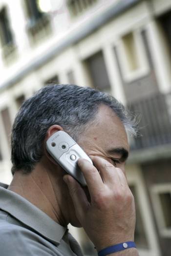 Un hombre mantiene una conversación desde su teléfono móvil.