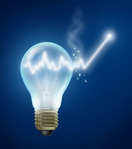 Investment Ideas and stock market concept with a shining light bulb with a stock graph chart as a bulb filament bursting out of the glass showing new growth and future success in business and finance.