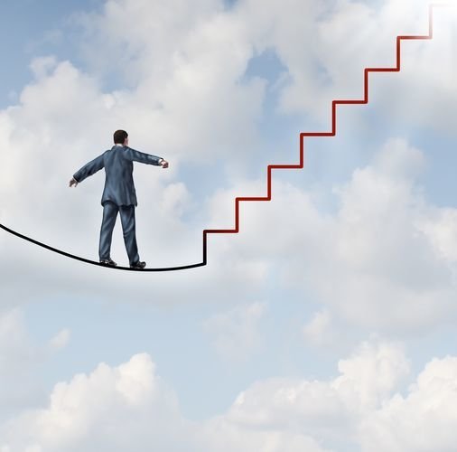Risk solutions and adapting to change as a business idea with a businessman walking on a dangerous high wire tightrope that transforms into a red staircase leading to a clear path to future opportunity and success.