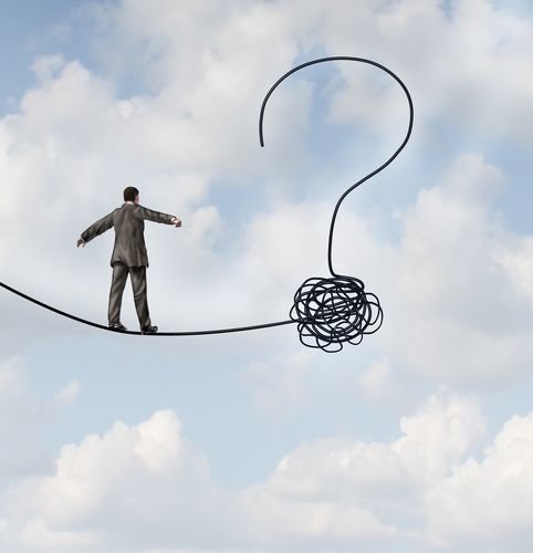 Risk uncertainty and planning a new journey as a businessman walking on a tight rope that getets tangled and shaped as a question mark as a metaphor for confusion at the road ahead as a business concept of finding solutions to change for success.