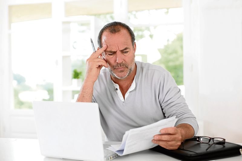 Senior man being puzzled with tax documents
