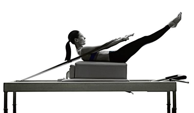 64788607 - one caucasian woman exercising pilates reformer exercises fitness in silhouette isolated on white backgound