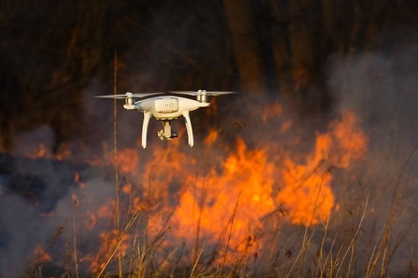 The drone flies against the background of a spring forest fire