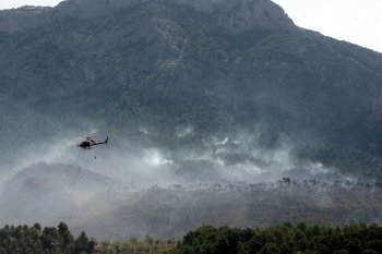 Un helicóptero sobrevuela la zona del incendio. (Foto: Jaume Sellart)