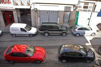 Vehículos estacionados diante de garaxes, na rúa Carlos Velo do Carballiño. (Foto:  Martiño Pinal  )