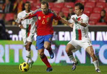 Iniesta conduce el balón ante el portugués Joao Pereira. (Foto: Antonio Cotrim)