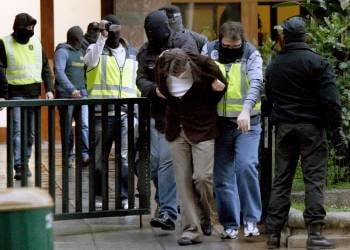 Varios agentes trasladan a uno de los atracadores detenidos en Bilbao. (Foto: ALFREDO ALDAI)