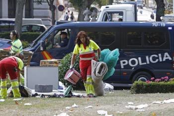 Los servicios municipales de limpieza retiran los residuos y los materiales dejados por el grupo de 'indignados' que permanecía acampado en el Paseo del Prado, junto a la plaza de la Cibeles, en Madrid, desde el 23 de julio, y que ha sido desalojado hoy p