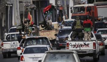 Rebeldes libios escoltan a miembros del Consejo de Transición por las calles de Trípoli. (Foto: H. HANSCHKE)