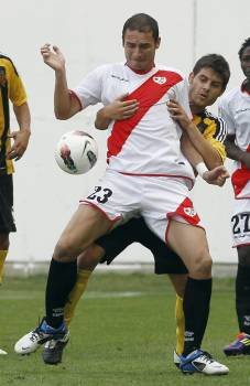 El delantero montenegrino del Rayo Vallecano, Andrija Delibasic, cubre la pelota ante la presión del defensa del Real Zaragoza, Javi Paredes (Foto: EFE)