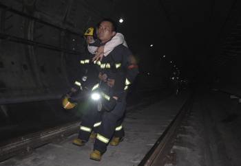 Miembros de los equipos de rescate ayudan a los al menos 40 pasajeros que han resultado heridos leves en el choque de dos trenes en la línea 10 del Metro de Shanghái  (Foto: EFE)