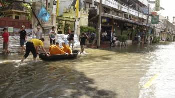 Dos monjes, transportados en barca por una calle de Bangkok, la metrópoli por la que avanza la tromba de agua que anega la meseta central de Tailandia.