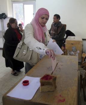 Una mujer ejerce su derecho al voto durante la primera ronda de las elecciones legislativas, en un colegio electoral en El Cairo (Egipto)