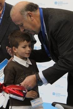 El seleccionador español de fútbol, Vicente del Bosque, felicita a uno de los galardones durante el acto de entrega de premios del XVIII Concurso Infantil 'Dibuja tu corbata' de Aldeas Infantiles SOS (Foto: EFE)