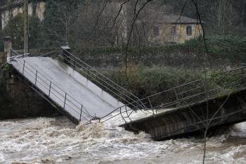 Las fuertes lluvias caídas sobre Asturias han provocado en las últimas horas diversas incidencias, entre las más destacadas el derrumbamiento de parte del puente del río Trubia (Foto: EFE)