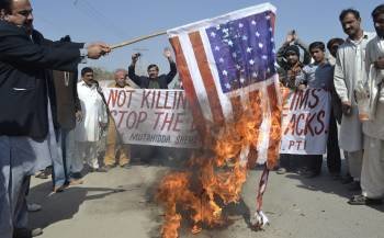 Paquistaníes incendian una bandera estadounidense durante una manifestación contra los ataques aéreos de EE.UU. sobre Pakistán, en Multan (Foto: EFE)