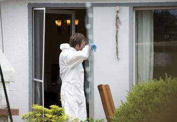  Un investigador recoge pruebas en la propiedad donde han sido encontrados los cuerpos sin vida de cuatro niños en Gross Ilsede (Alemania)