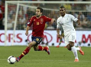 El defensa español Jordi Alba (i) escapa con el balón del francés Florent Malouda (d) durante el encuentro de cuartos de final de la Eurocopa 2012 entre las selecciones de España y Francia hoy (Foto: EFE)