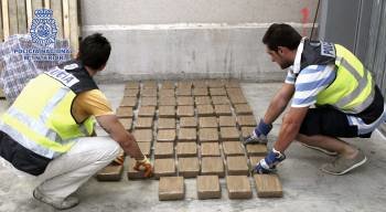 Dos policías contabilizan droga incautada en una de las últimas operaciones en España.