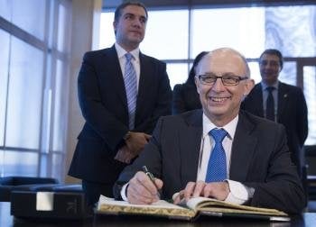 El ministro de Hacienda, Cristobal Montoro, firma en el libro de autoridades durante su visita a la Diputación de Málaga (Foto: EFE)