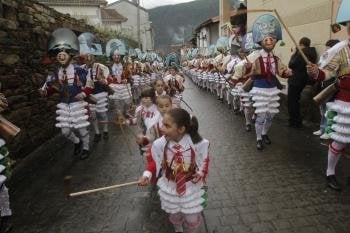 Desfile de peliqueiros, adultos y niños, por las calles de Laza. Era la llamada 'estrea', que los concentra en la Praza da Picota a la salida de misa.