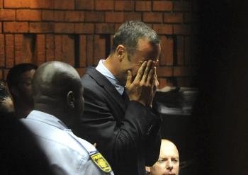 El atleta sudafricano Oscar Pistorius rompe a llorar ante el fiscal Gerrie Nel, que le acusó formalmente del asesinato de su novia.