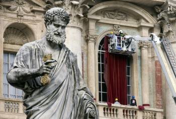 Personal del Vaticano decora un balcón de la Basílica de San Pedro, un día antes del cónclave. (Foto: CLAUDIO PERI)