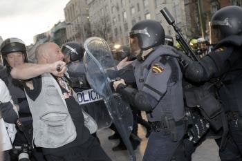 Un manifestante  se enfrenta a varios miembros de la Policía Nacional en la plaza de Neptuno,  durante la protesta contra las principales instituciones del Estado (Foto: EFE)