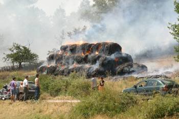 Un grupo de vecinos observa impotente cómo arden las pacas. (Foto: JOSÉ PAZ)