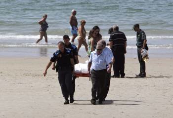Traslado del cadáver de la mujer ahogada el pasado miércoles en la playa de Patos (Nigrán). (Foto: SXENICK)