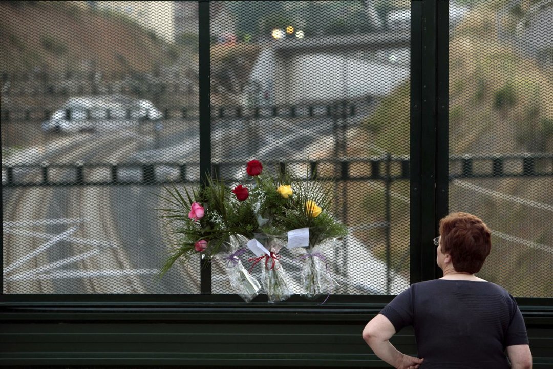 Flores en recuerdo de las víctimas en un puente próximo al lugar del accidente de tren ocurrido en Santiago de Compostela (Foto: efe)