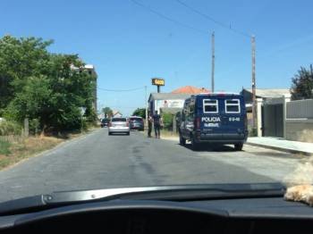 Varios coches policiales y agentes, apostados a la entrada del poblado gitano. (Foto: X.F.)