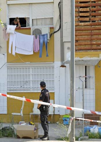 Un policía, junto a la vivienda de la niña fallecida. (Foto: MANOLO RUS)