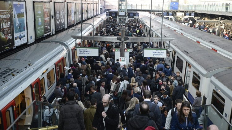 Decenas de pasajeros esperan la llegada del metro en la estación de Earls Court