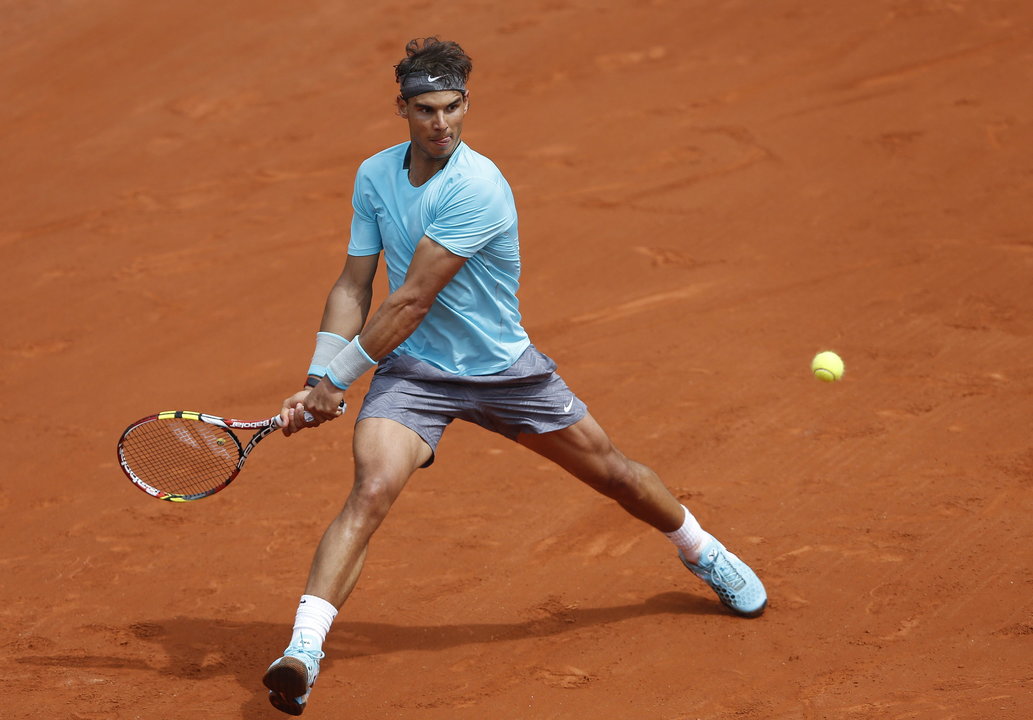 El tenista español Rafael Nadal devuelve la bola al serbio Dusan Lajovic en un partido de octavos de final del torneo Roland Garros