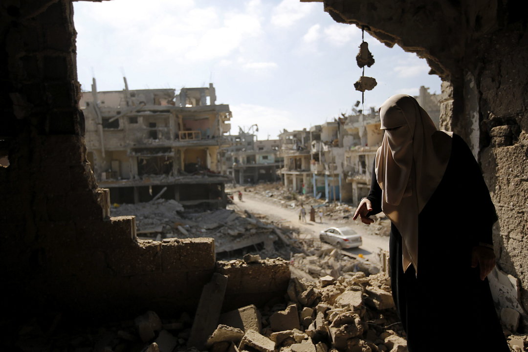Una mujer camina entre los escombros de sus casas destruidas en la ofensiva israelí sobre Gaza en los útlimos días en el barrio de Al Shejaeiya