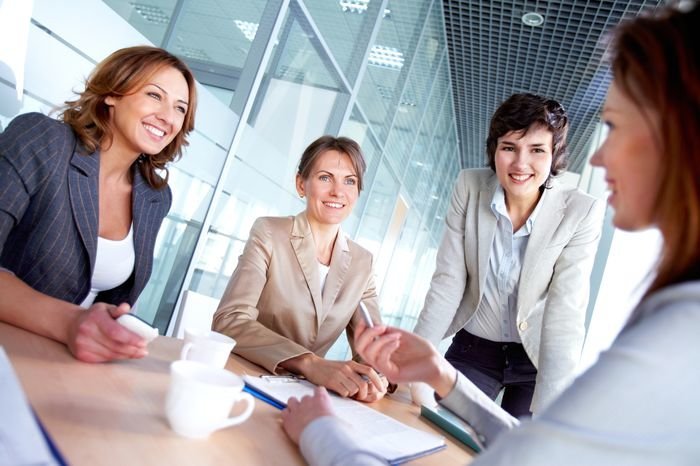 Image of successful females listening to colleague at meeting