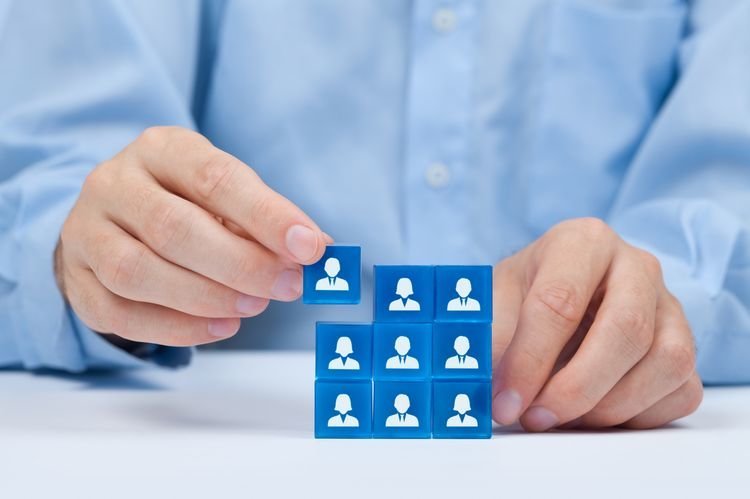 Human resources, social networking, assessment center concept, personal audit or CRM concept - recruiter complete team by one person. Employees are represented by blue glass cubes with icons.