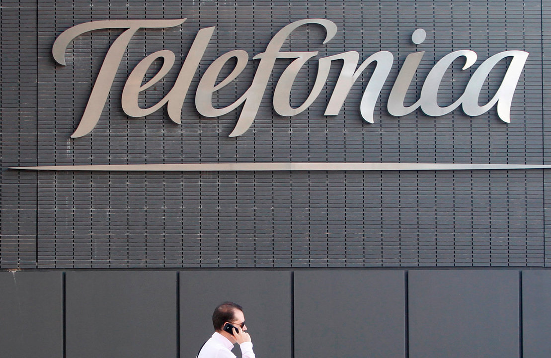 A man talks on a cell phone outside the Telefonica headquarters in Madrid Wednesday July 28, 2010.(AP Photo/Paul White)