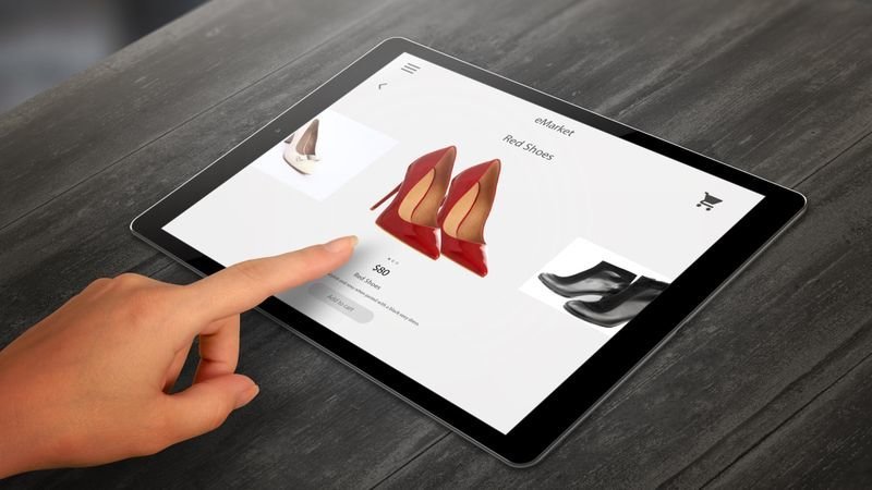 Shopping with tablet. Woman buy red shoes on online market. 