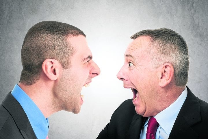 Angry businessman shouting to a colleague