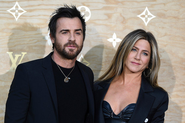 US actor Justin Theroux (L) and his wife US actress Jennifer Aniston (R) pose during a photocall ahead of a diner for the launch of a Louis Vuitton leather goods collection in collaboration with US artist Jeff Koons, at the Louvre in Paris on April 11, 2017. (GABRIEL BOUYS/AFP/Getty Images)