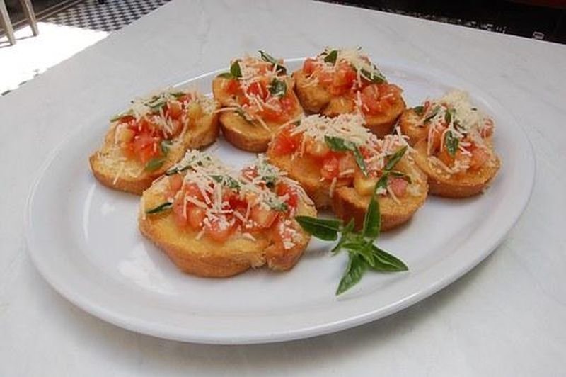 Tostada integral con queso bajo en grasa y tomate fresco, un ejemplo de merienda.