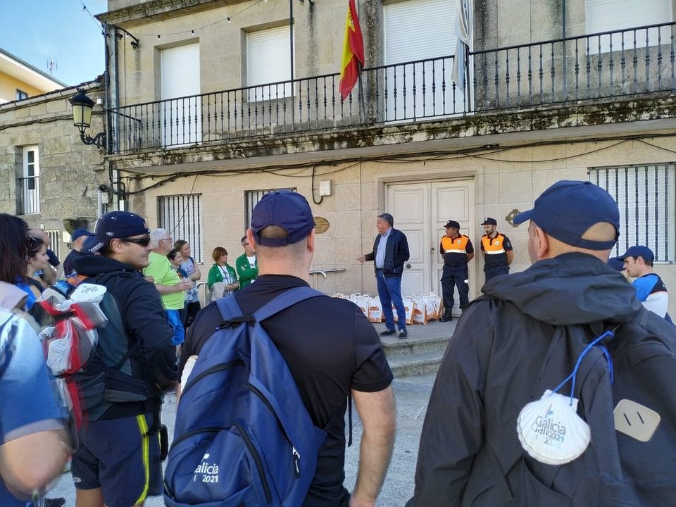 El alcalde de Cea, José Luis Valladares y dos voluntarios con un grupo de peregrinos.