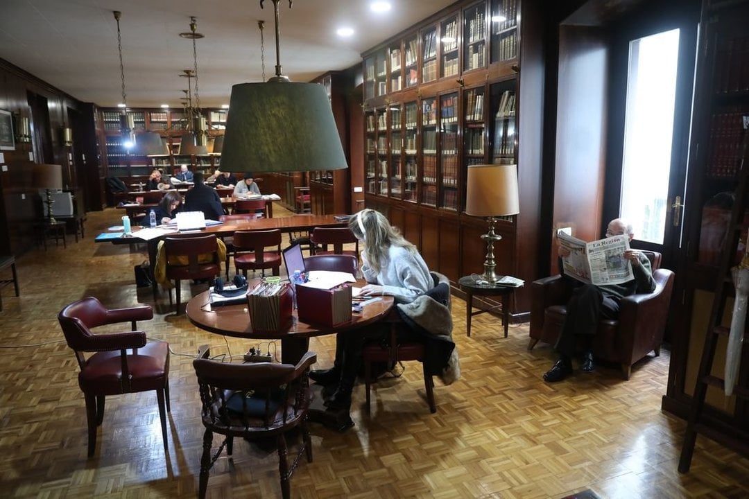 Opositores estudian en la mesa mientras otros socios leen la prensa en los sofás de la biblioteca del Liceo. (Foto: José Paz)