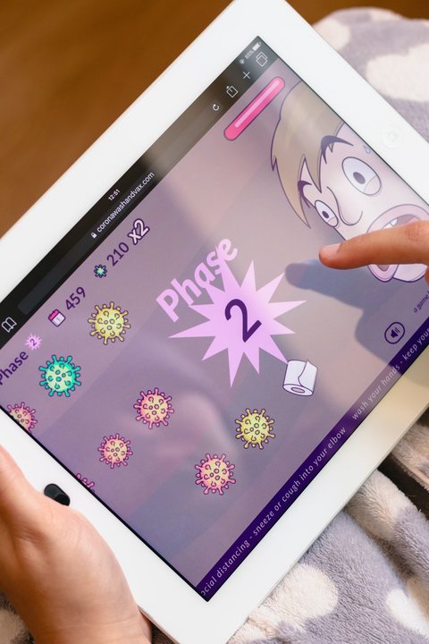 Una joven juega con un videojuego inspirado por el coronavirus. (Foto: Unsplash)